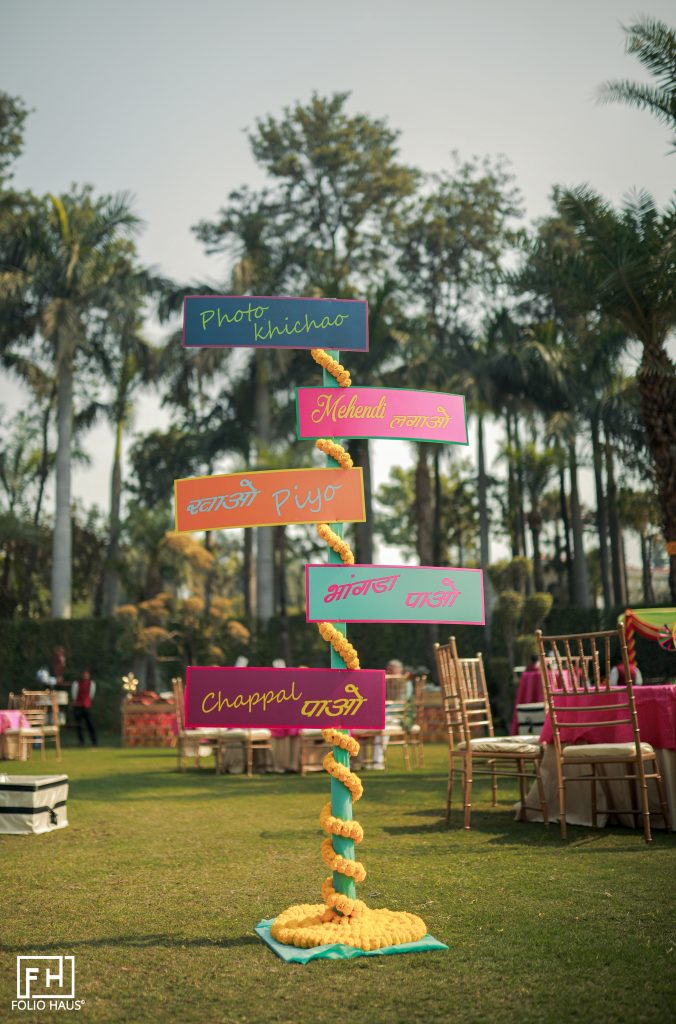 fun outdoor guiding wedding sign post with tags