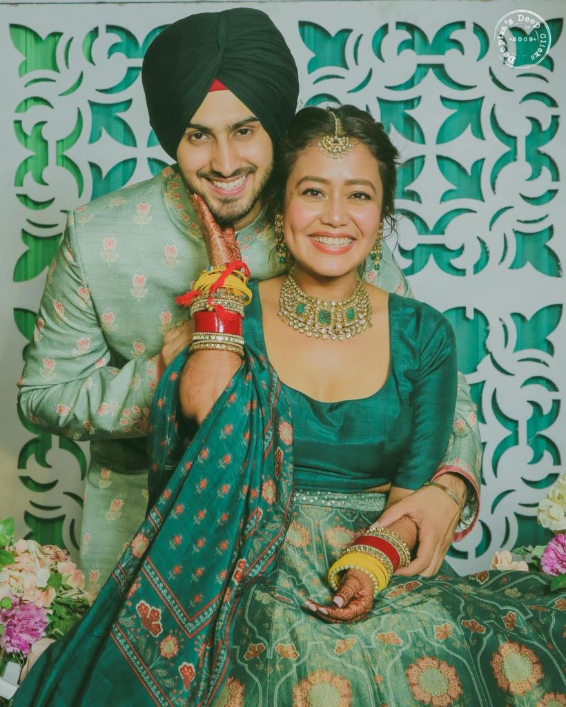 bride neha kakkar and groom rohanpreet posing for mehendi ceremony celebrations 