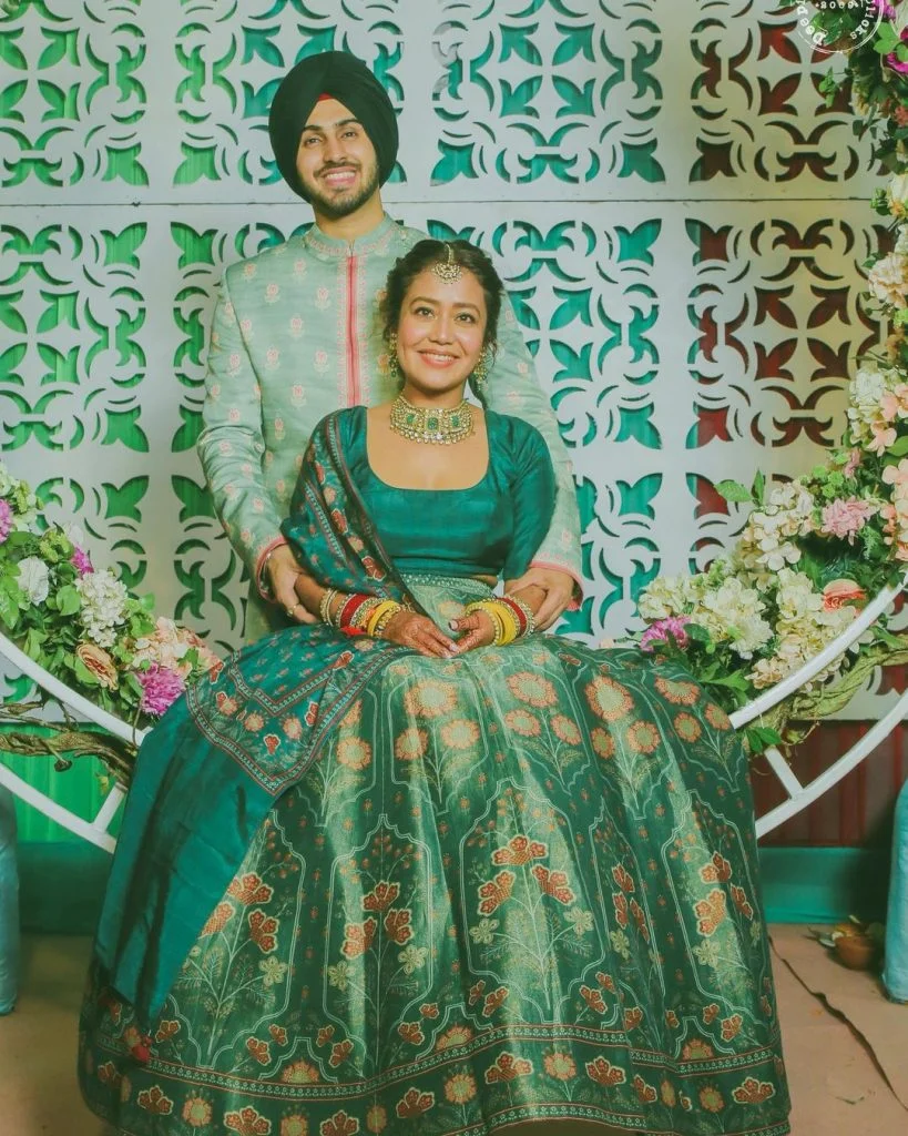 green anita dongre floral mehendi lehenga and groom kurta for neha kakkar wedding