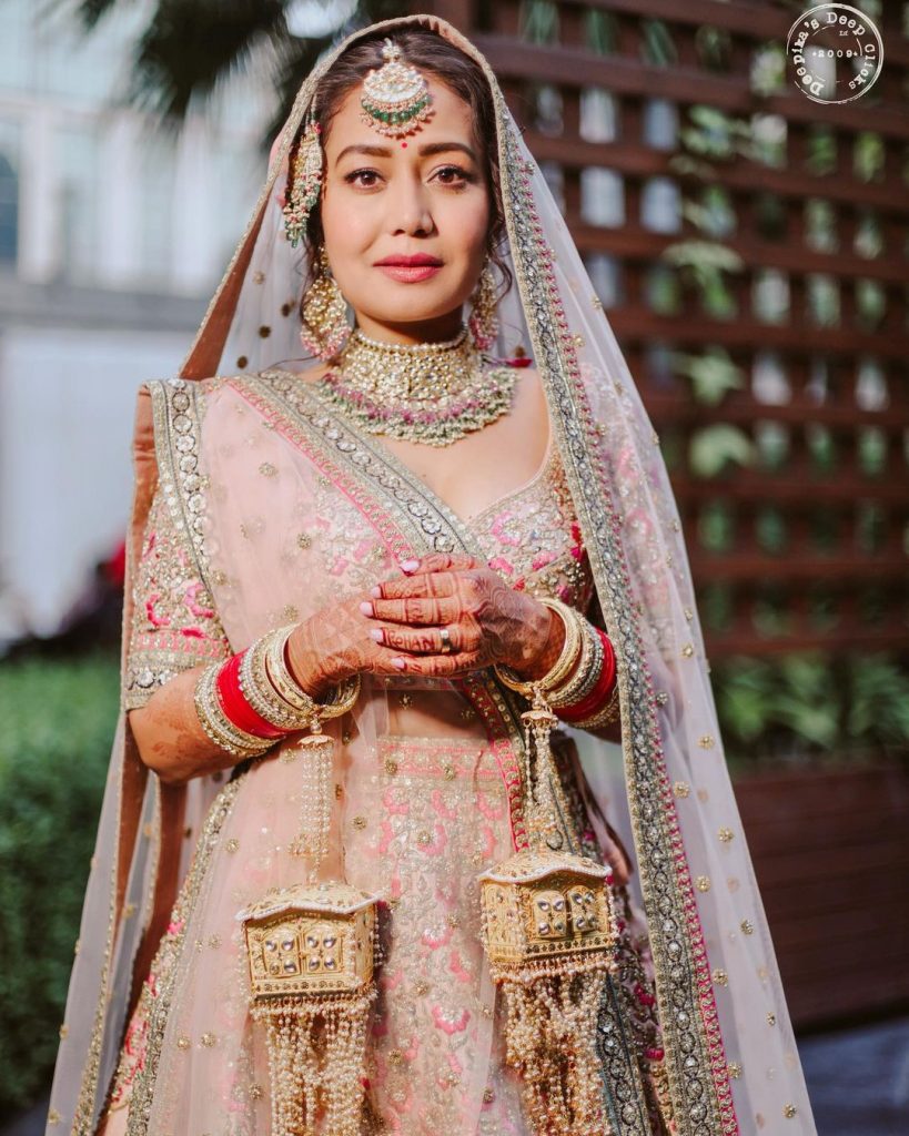 neha kakkar embroidered pastel blouse and heavy pink dupatta sabyasachi lehenga with golding hanging kaleeras and gold pink bridal choker