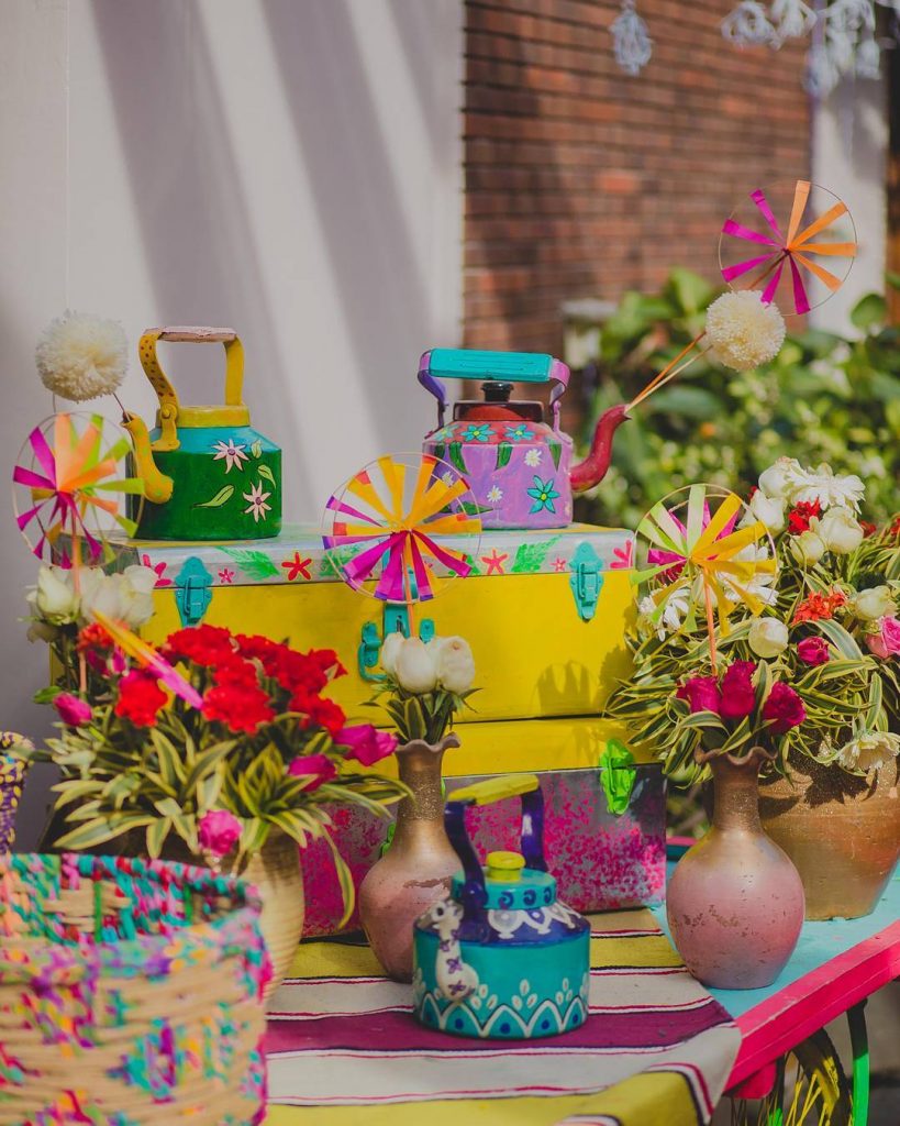 painted quirky teapot and pinwheel Indian home wedding decor