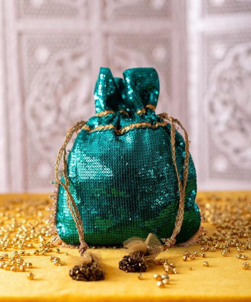 green colored sequin sachet for neha kakkar wedding by Pataaree