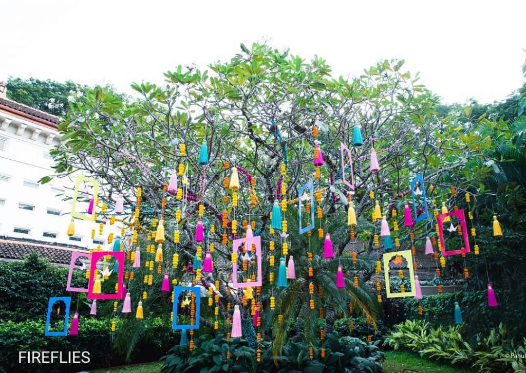 DIY tassels hanging down from an outdoor wedding tree