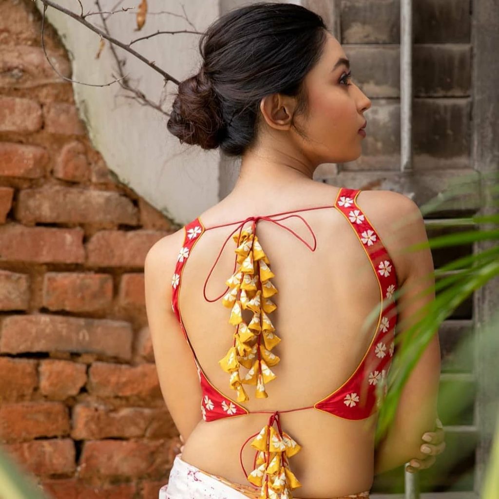 Backless Choli Blouse Design With Fabric Tassels For White Lehenga