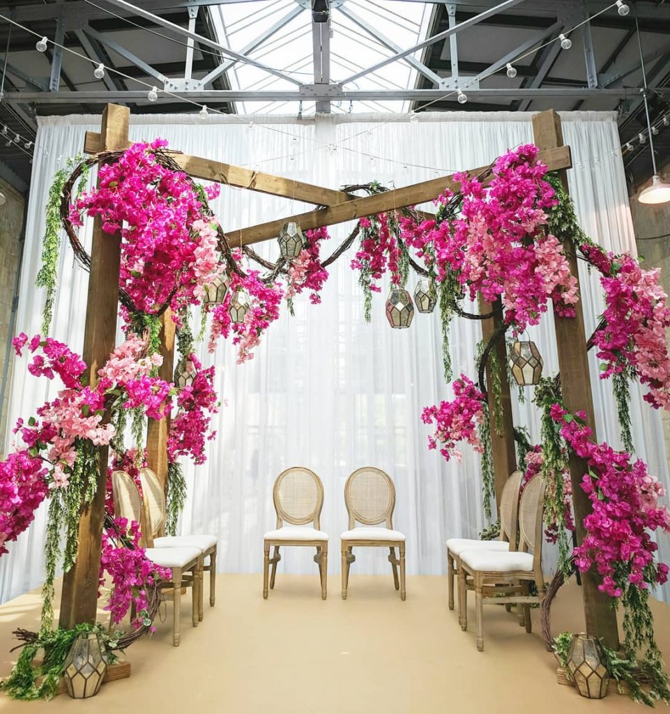 indoor mandap decorated with flowers and foliage