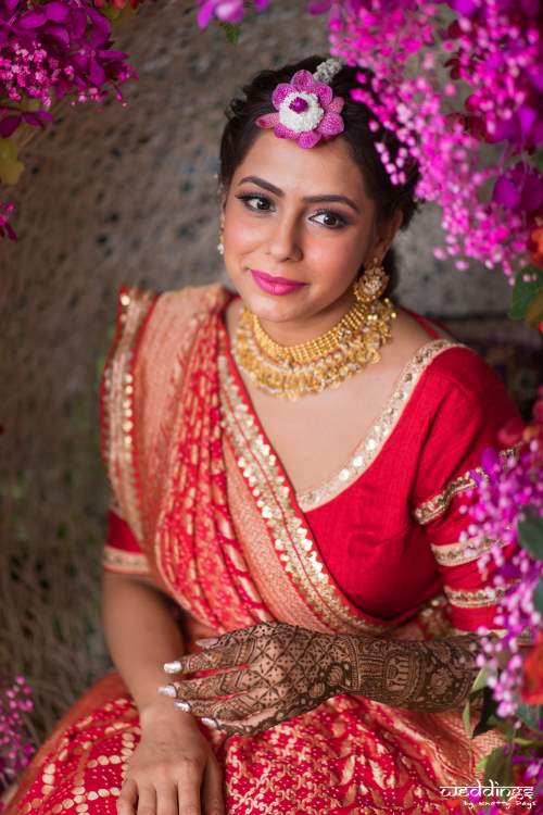 Red lehenga with gold jewellery and pink makeup for mehendi at Hua hin, Thailand