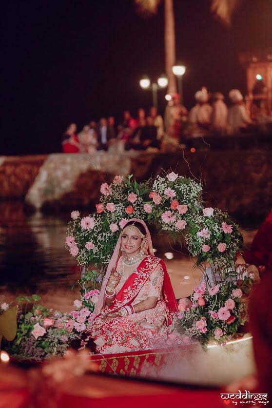 Beautiful bridal entry on boat by the lakeside at this Dusit Thani Hua Hin Wedding in Thailand