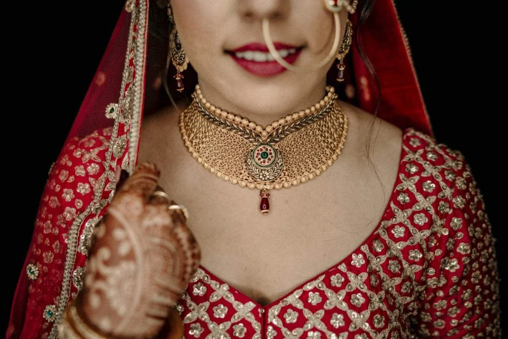 red bridal lehenga with gold jewellery