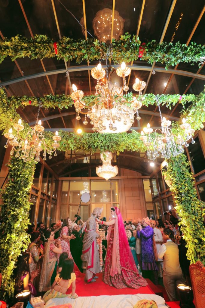 indoor mandap decoration idea with foliage and lights