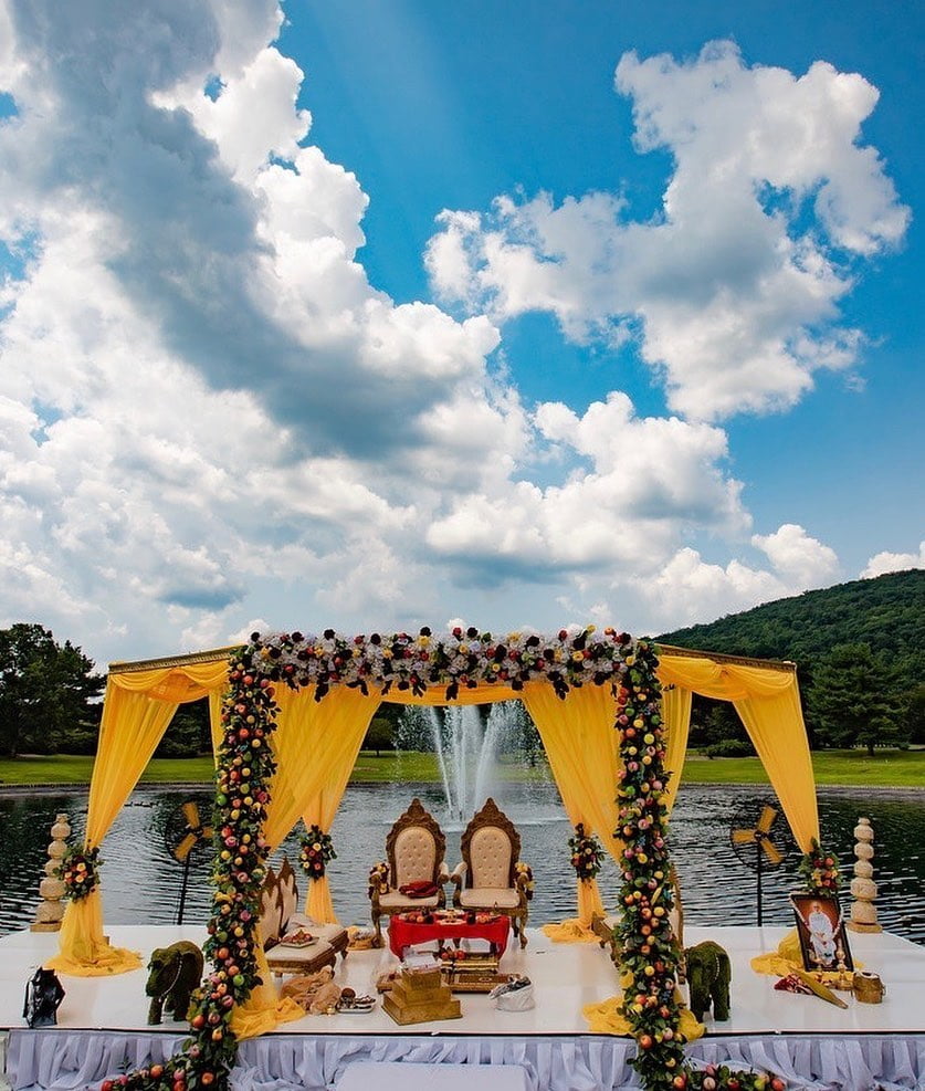 outdoor yellow mandap decked up with flowers