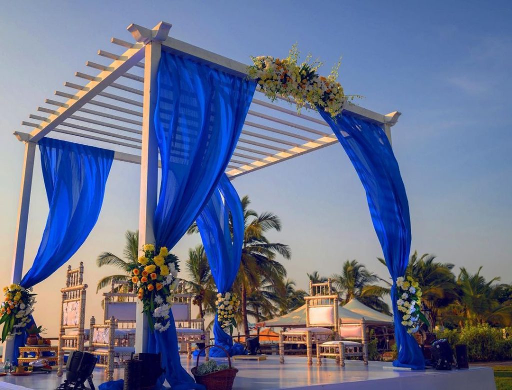 outdoor marriage mandap decoration with blue drapes