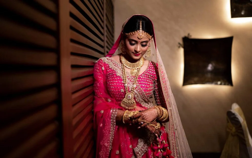 bridal pink lehenga with gold jewellery