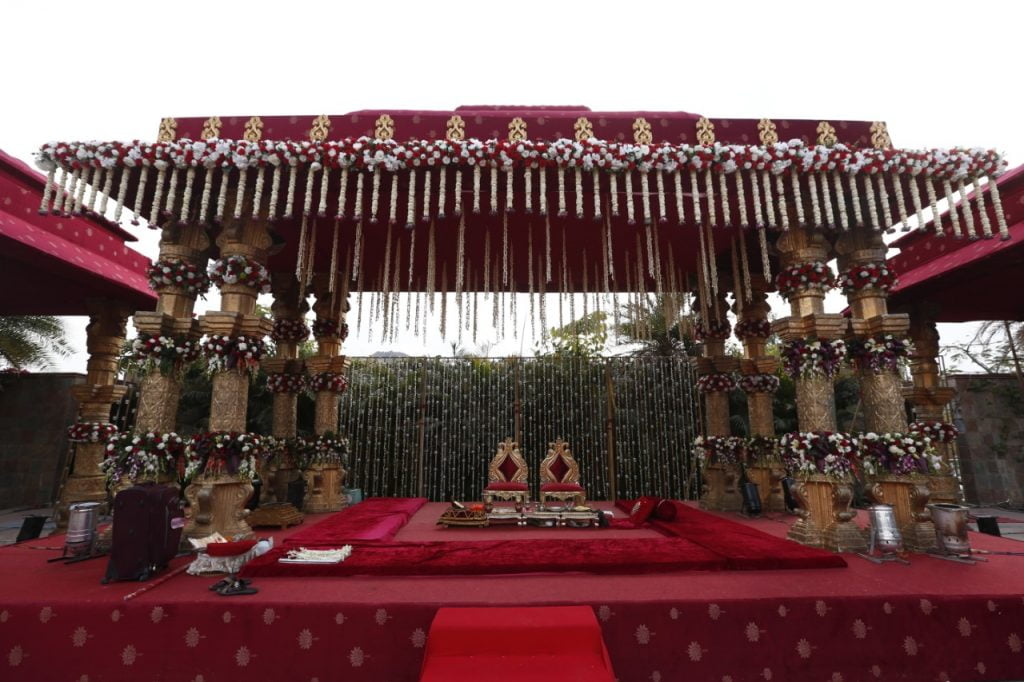 traditional vintage mandapam decoration in red and gold tones