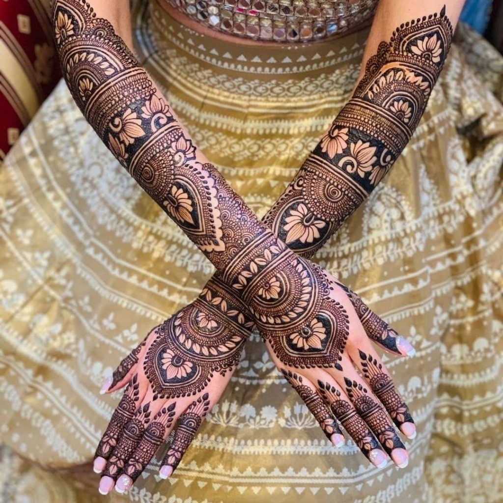 Exquisite full hand bridal mehndi design with lotus motifs