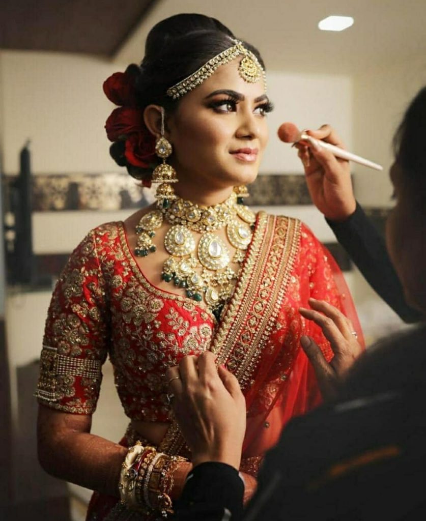 bride getting her makeup touched up