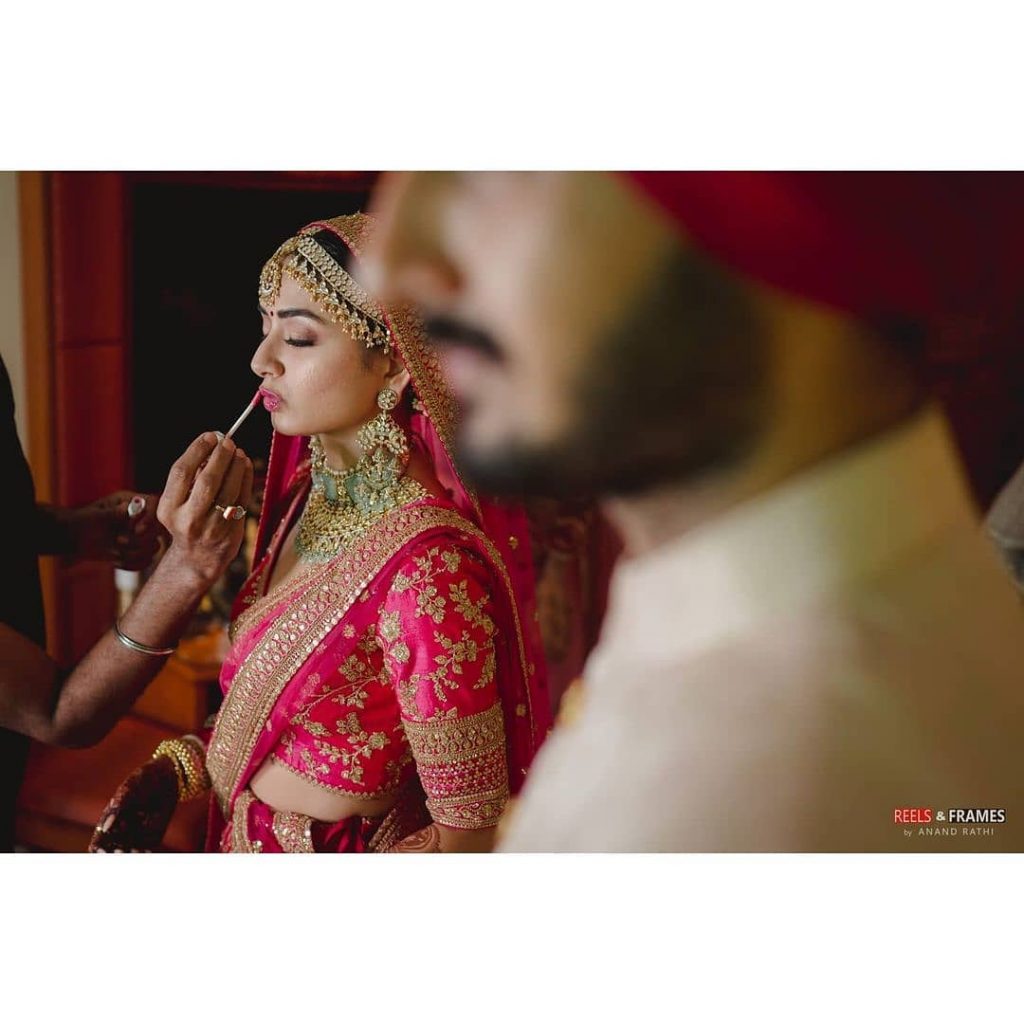 bride getting her lipstick touched up