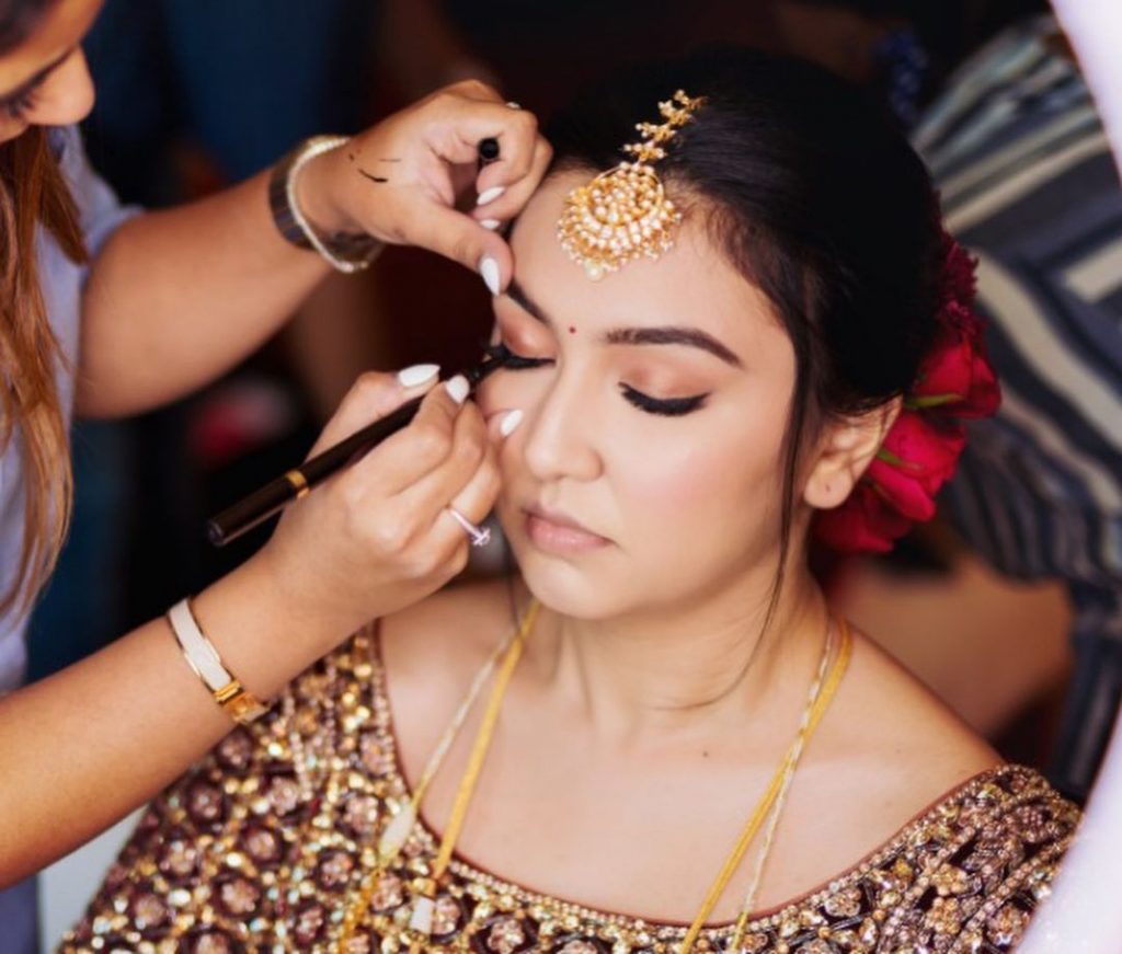 bride getting her eyes glammed up with eyeliner from her eye makeup kit product list