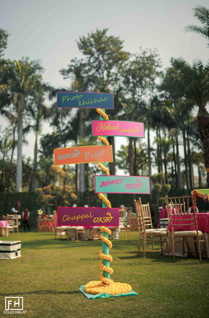 colourful signage decorated with marigolds for mehendi function