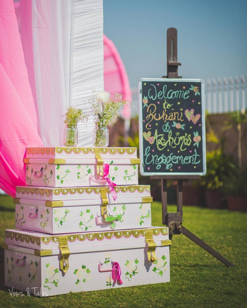 old trunks and blackboards painted and decorated with flowers as mehendi decoration ideas