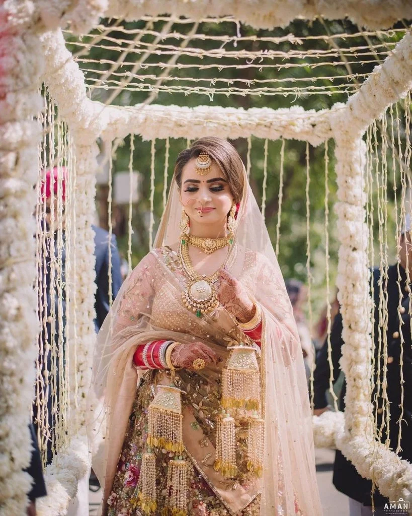 bride entering in a floral cage