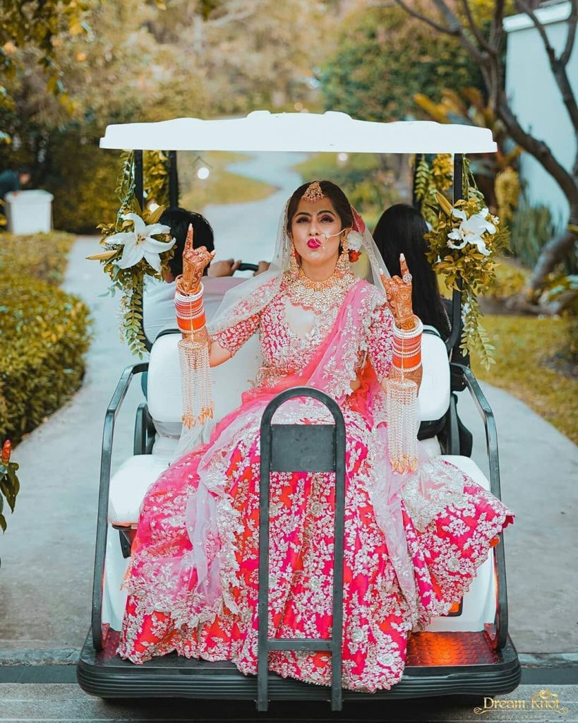 Quirky bridal entry in a golf cart