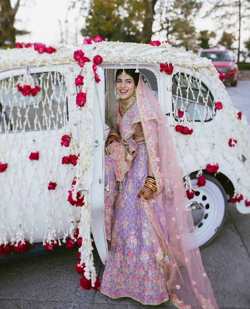 wedding entry idea for bride in a vintage car