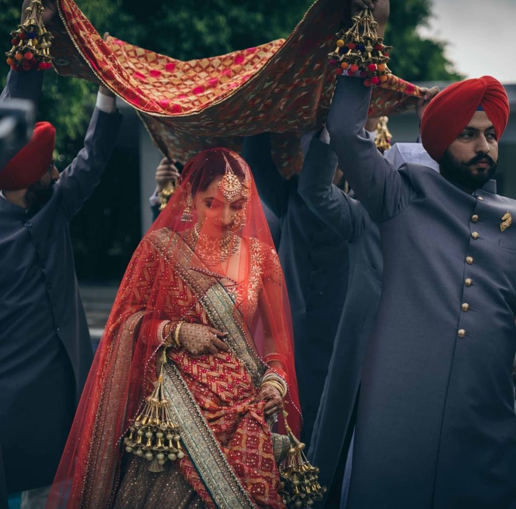 traditional bridal entry under a chaadar