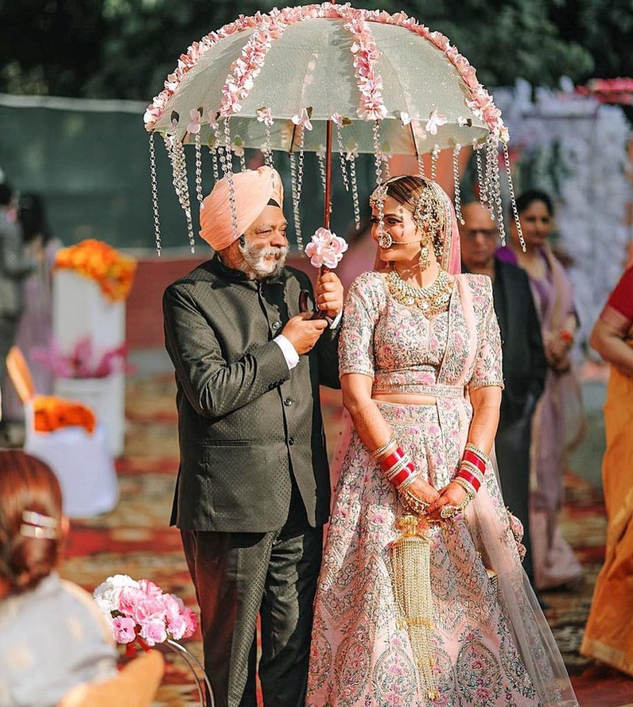Unique wedding entry idea for bride under a lace umbrella