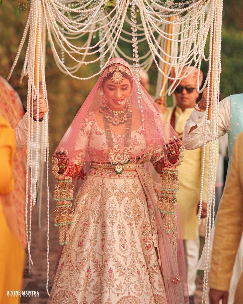 bridal entry under a pearl beaded phoolon ki chaadar