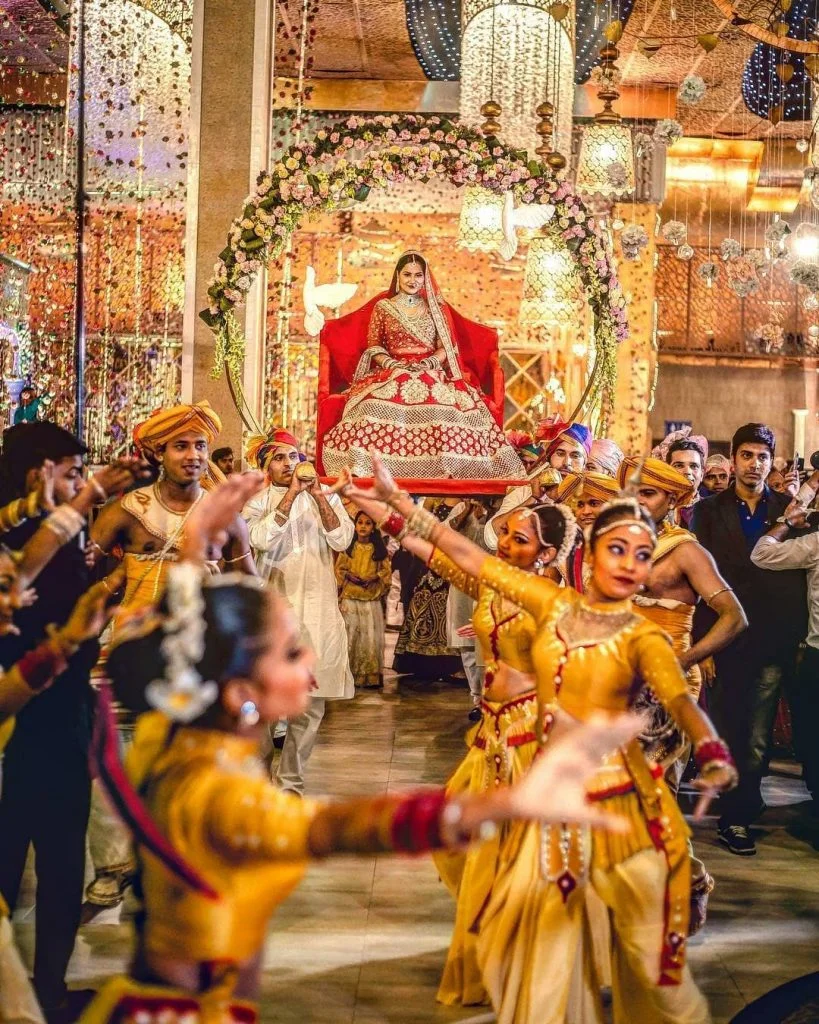 Unique floral doli bridal entry with dancers