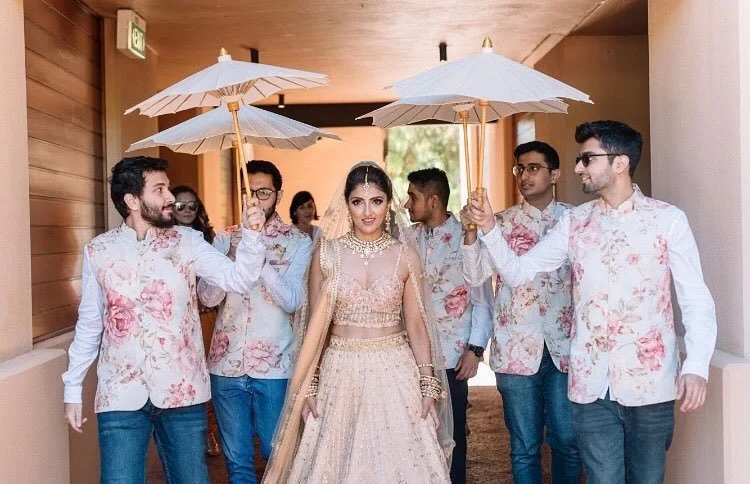 bridal entry with brothers holding paper umbrella