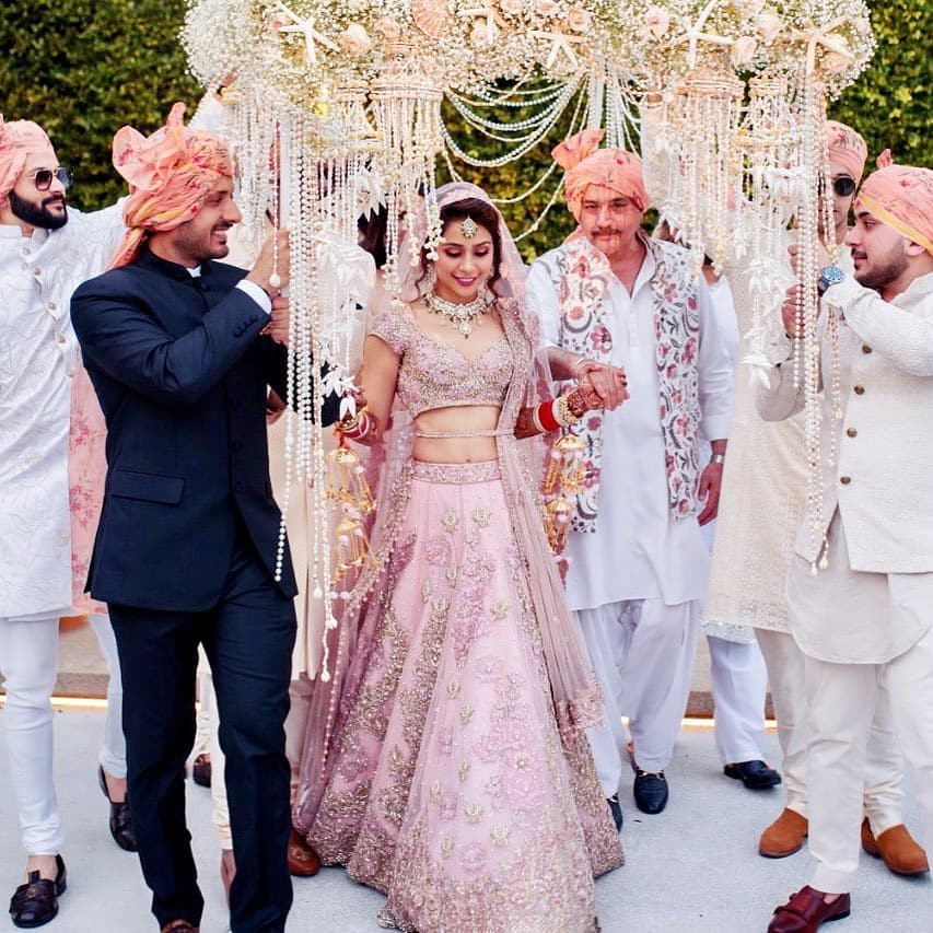 bridal entry with a pearl and flower decked canopy