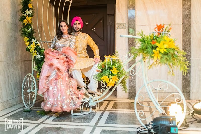 cycle decorated with yellow flowers and vines as mehendi decoration ideas