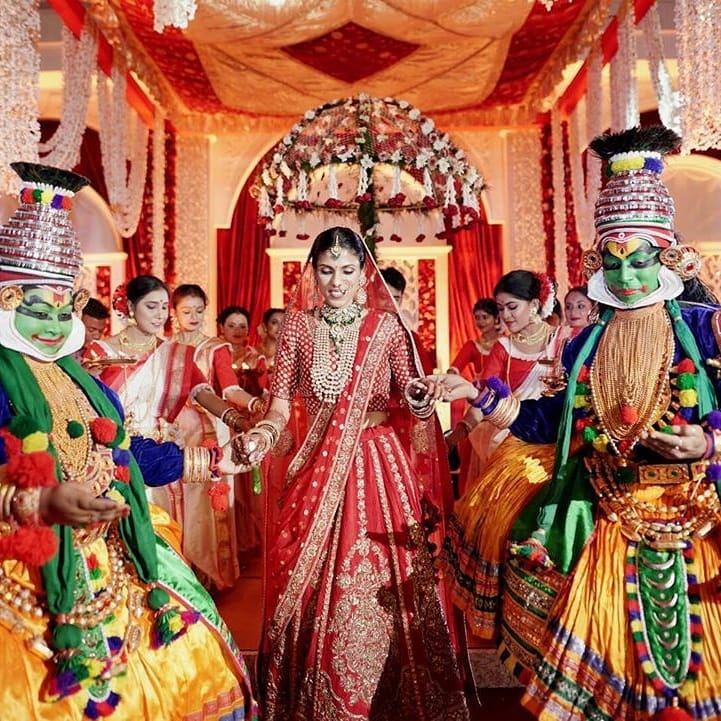 bridal entry with umbrella and dancers