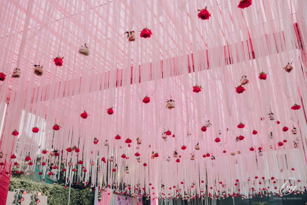 ceiling decorated in pink tones with roses for mehndi function