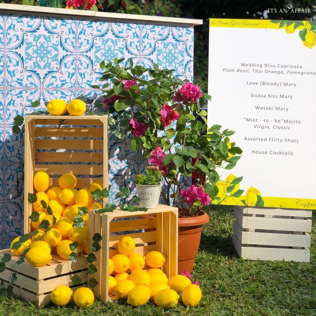 Signage decorated with fresh pink flowers and mangoes as mehendi decoration ideas