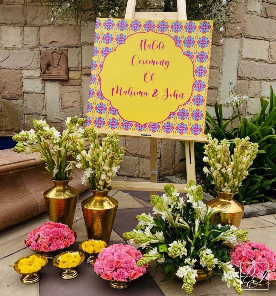 signboard with flowers and golden vases