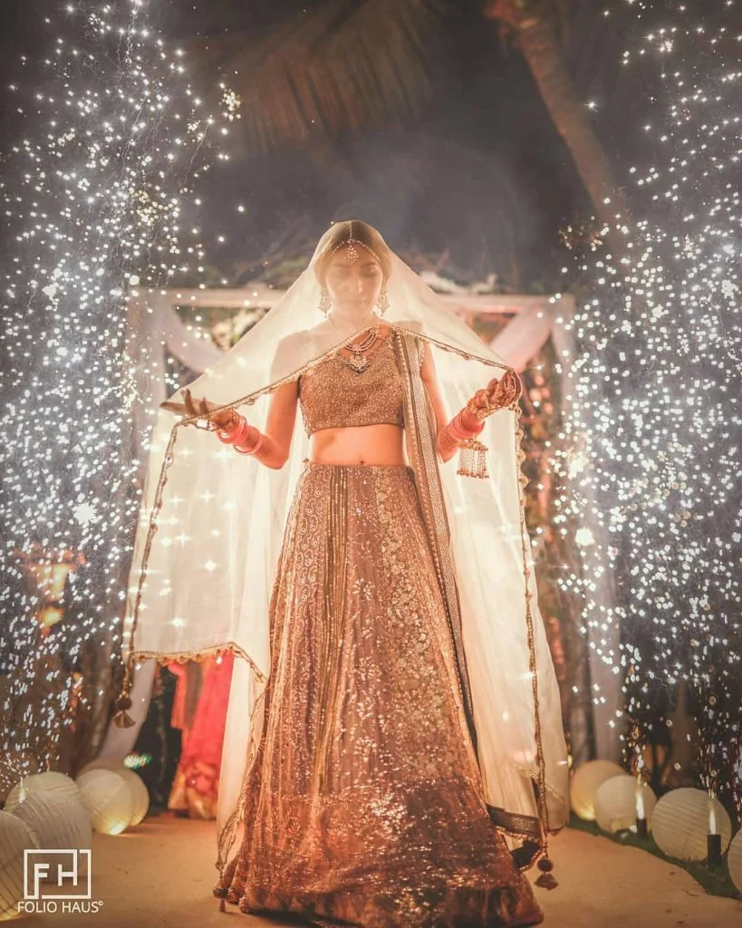 Bride entering with dupatta veil and fireworks
