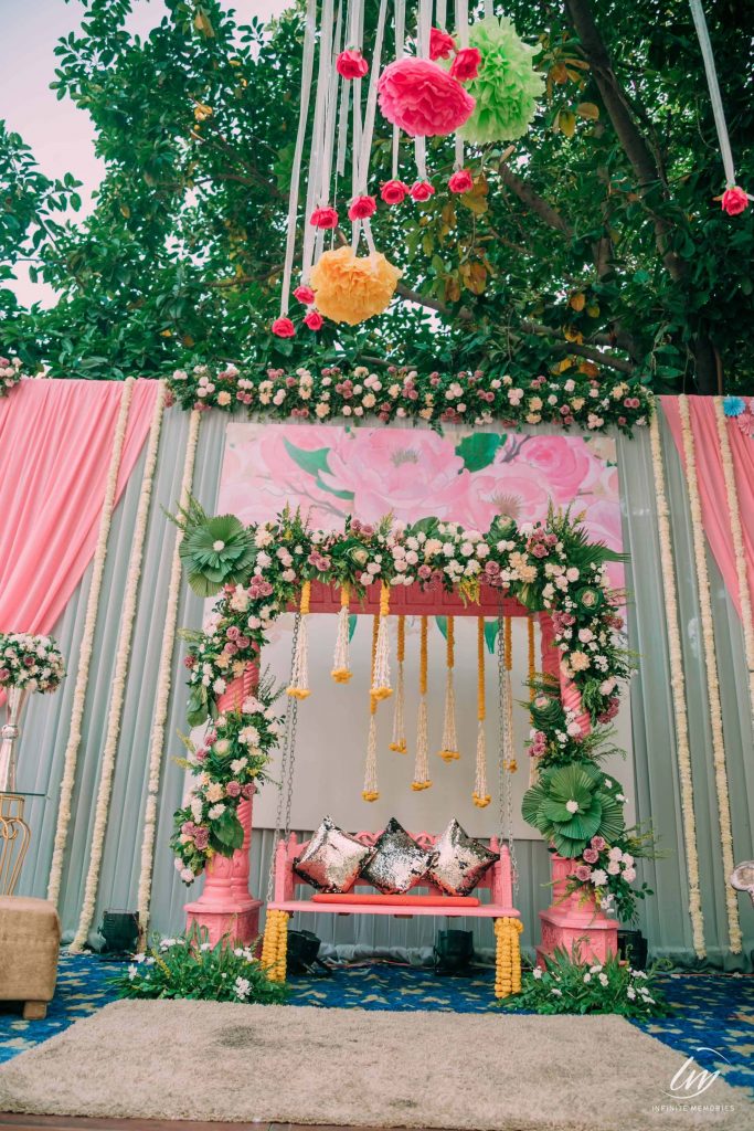 swing decorated with pink flowers and vines