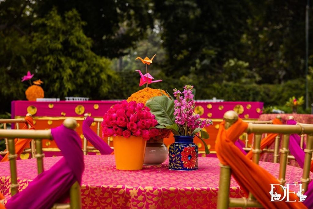 table decoration with flowers and old kettles