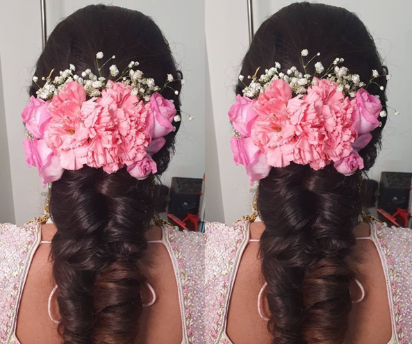 french braid adorned with fresh pink flowers