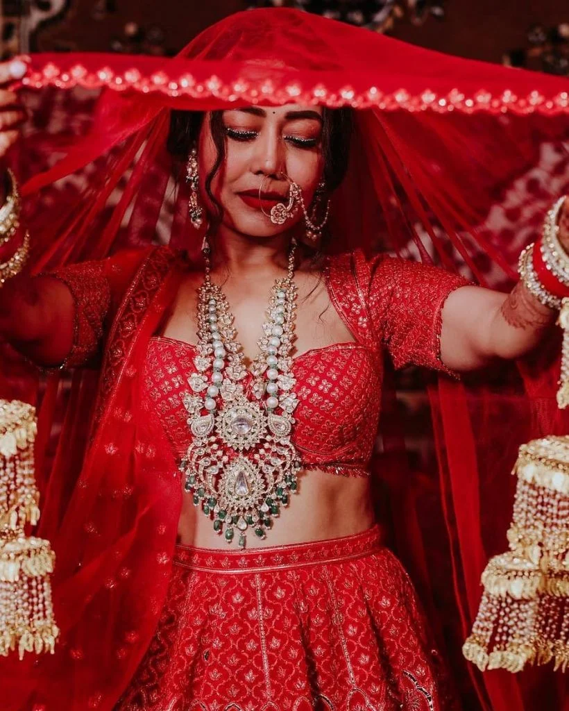 Neha Kakkar wearing a heavy diamond long necklace with sweetheart neckline