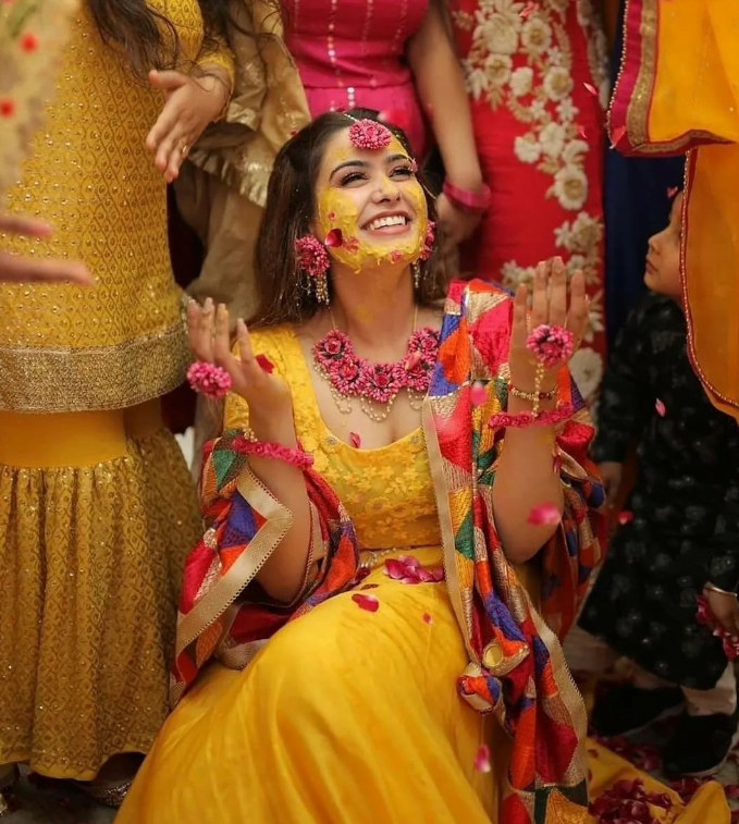 Haldi photoshoot poses with smiling bride