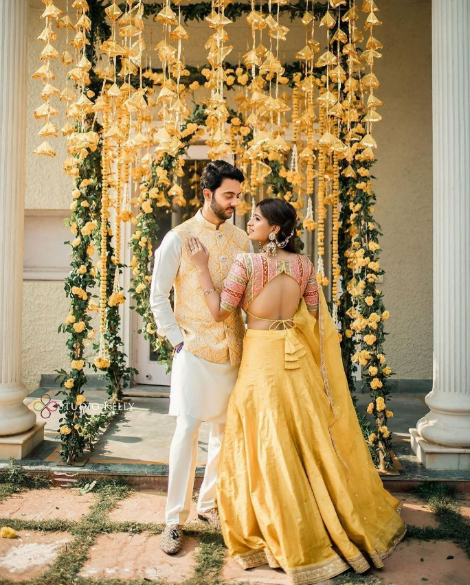 Haldi photoshoot poses for couples with backdrop