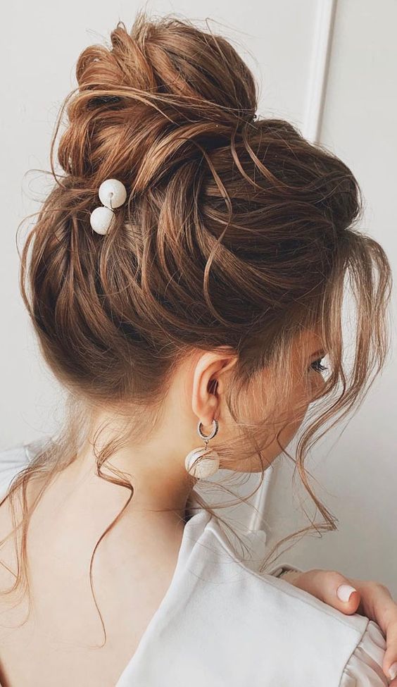 top-knot-high-bun-hairstyle-with-gown | WedAbout