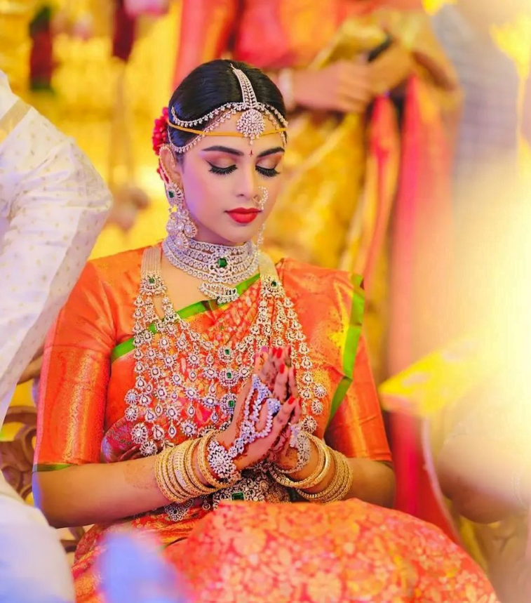 south indian bridal look in orange Kanjeevaram pattu saree and diamond jewellery