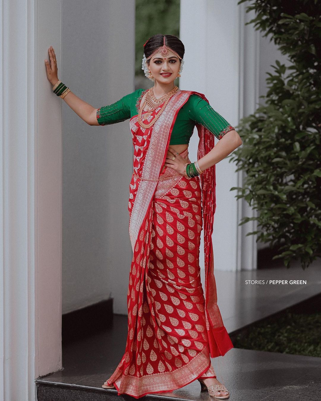 South Indian bride in red wedding silk saree with green blouse