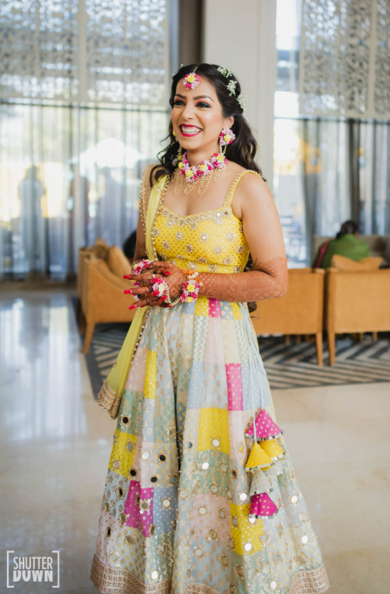 pastel yellow and blue haldi lehenga with mirror work