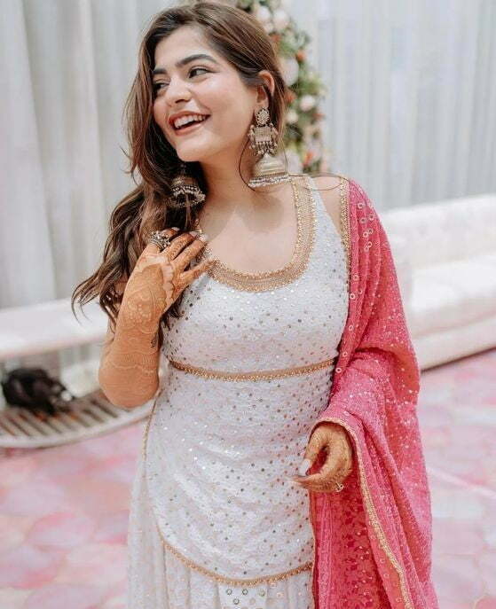 white chikankari haldi suit dress for bride with pink dupatta