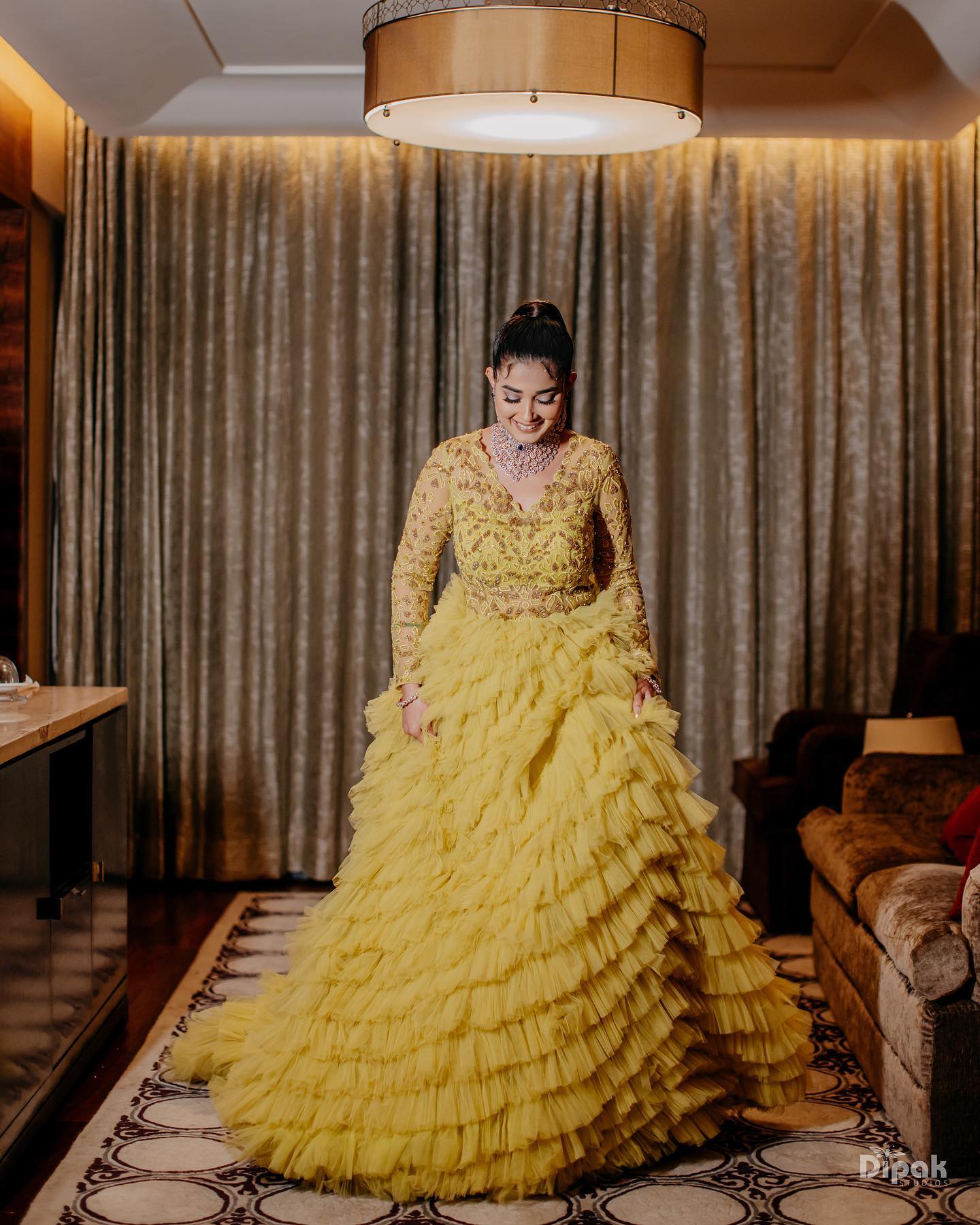 yellow ruffled and tiered haldi gown outfit for bride
